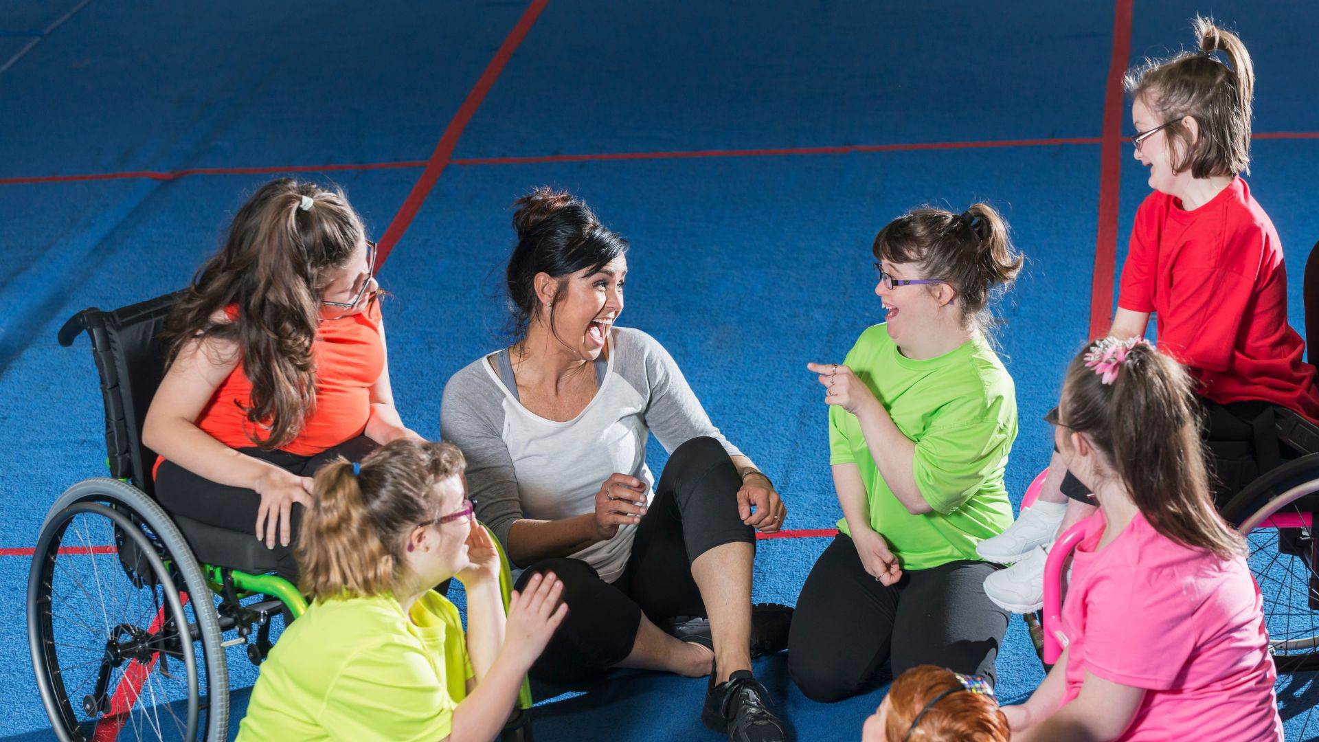 Group of special needs girls with instructor in gym