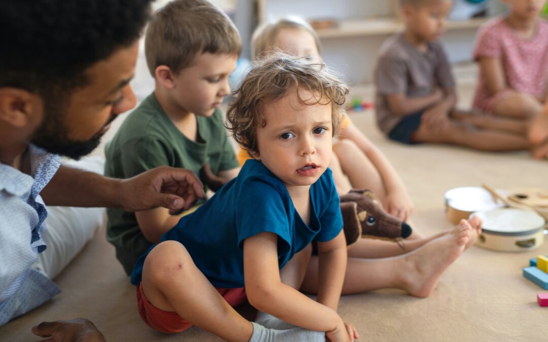 a-man-teacher-talking-to-small-unhappy-boy