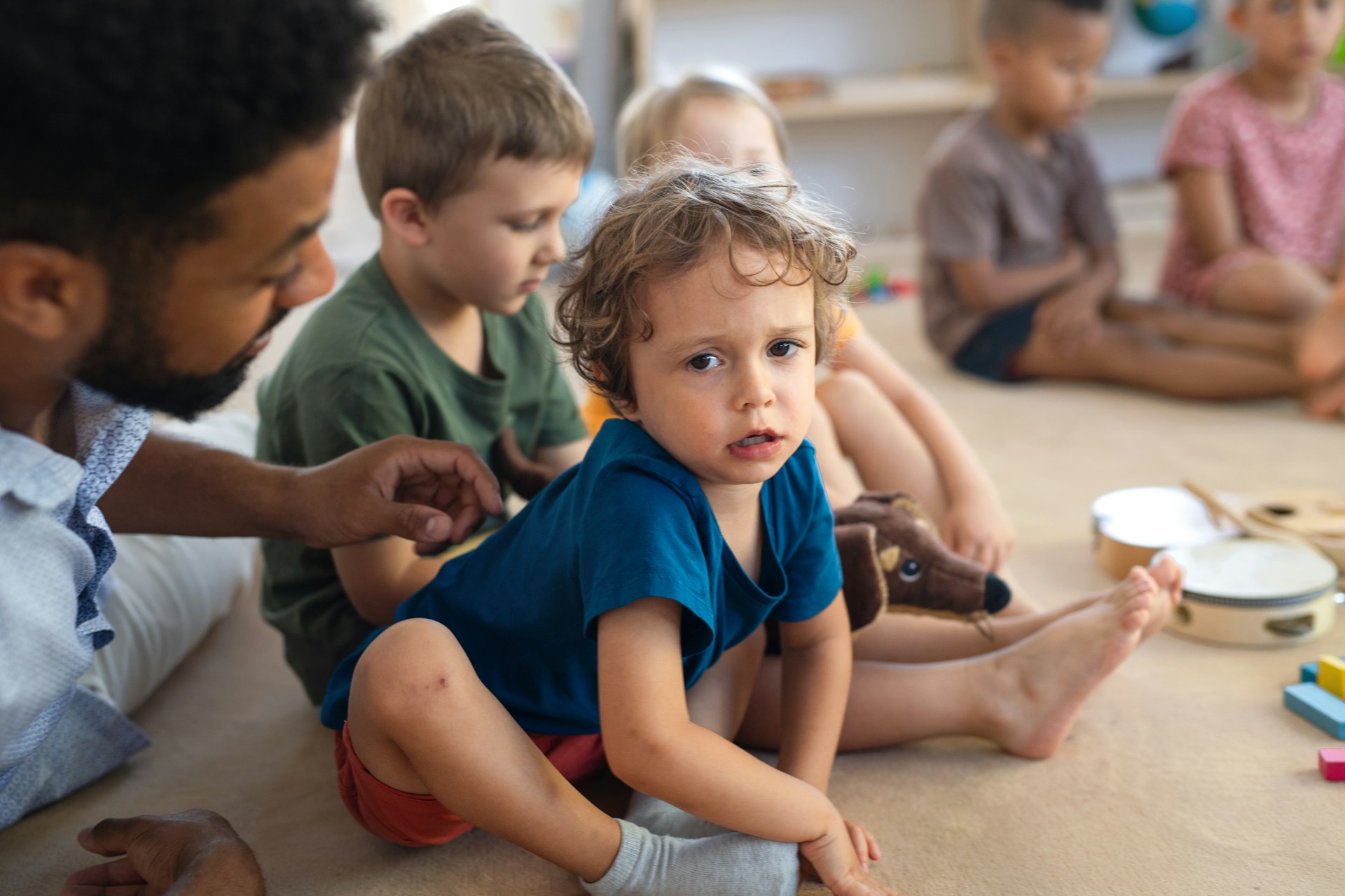 a-man-teacher-talking-to-small-unhappy-boy